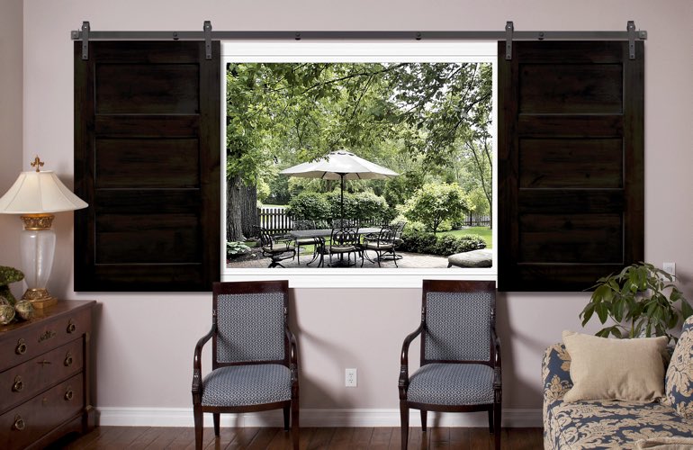 Dark brown sliding barn door shutters in family room